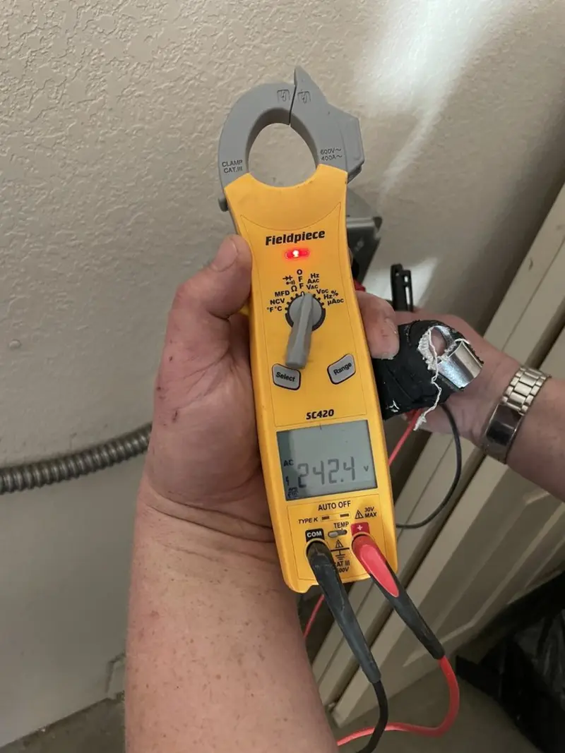 Voltage testing with clamp meter during Outlet Installation in Lemay